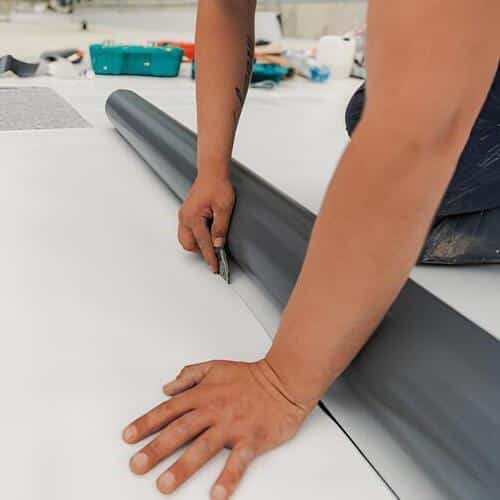 worker installing TPO roofing
