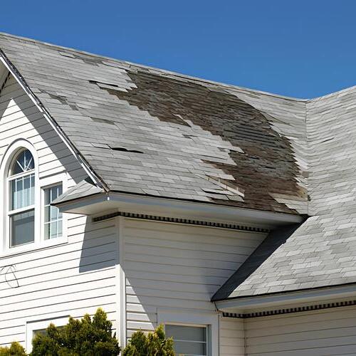 a severely storm damaged shingle roof
